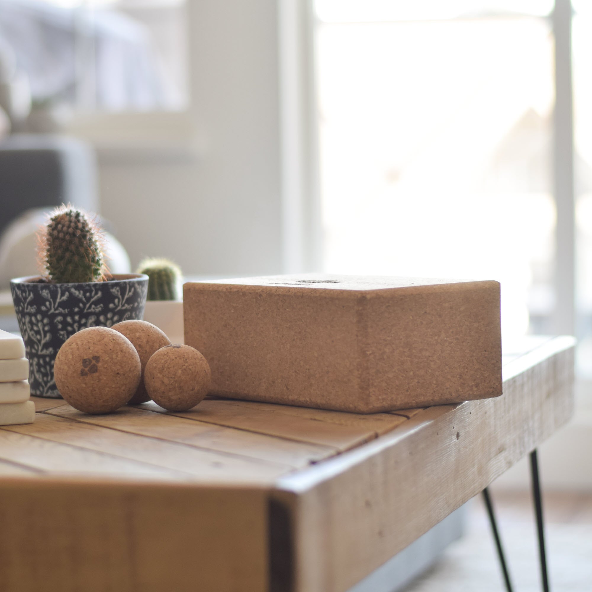 Cork Massage Ball Trio on a table next to the block